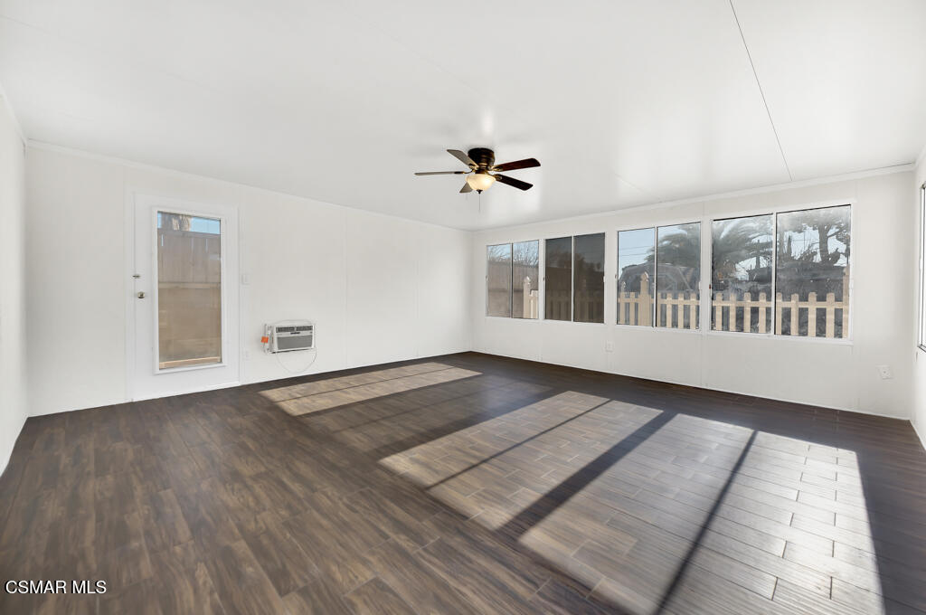 39202 Willowvale Road Palmdale, CA 93551 - Photo 15 of 36 an empty room with wooden floor and windows
