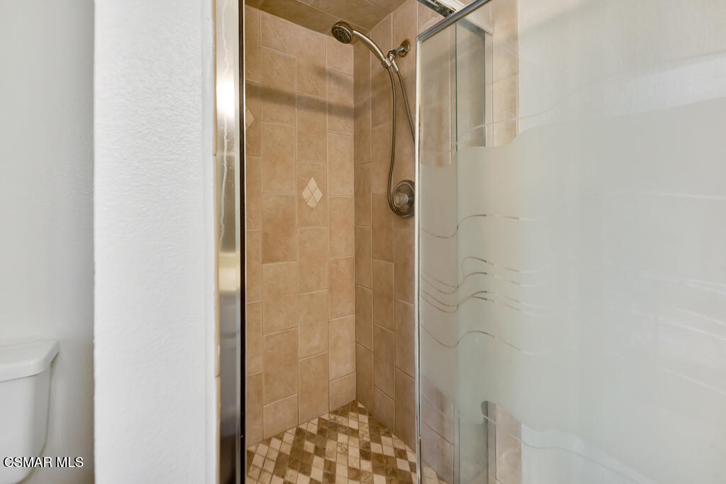 39202 Willowvale Road Palmdale, CA 93551 - Photo 20 of 36 a bathroom with a shower and a door