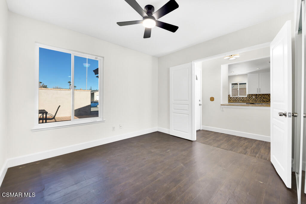 39202 Willowvale Road Palmdale, CA 93551 - Photo 21 of 36 a view of an empty room with a window and wooden floor