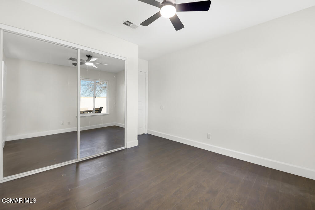 39202 Willowvale Road Palmdale, CA 93551 - Photo 22 of 36 an empty room with wooden floor and windows