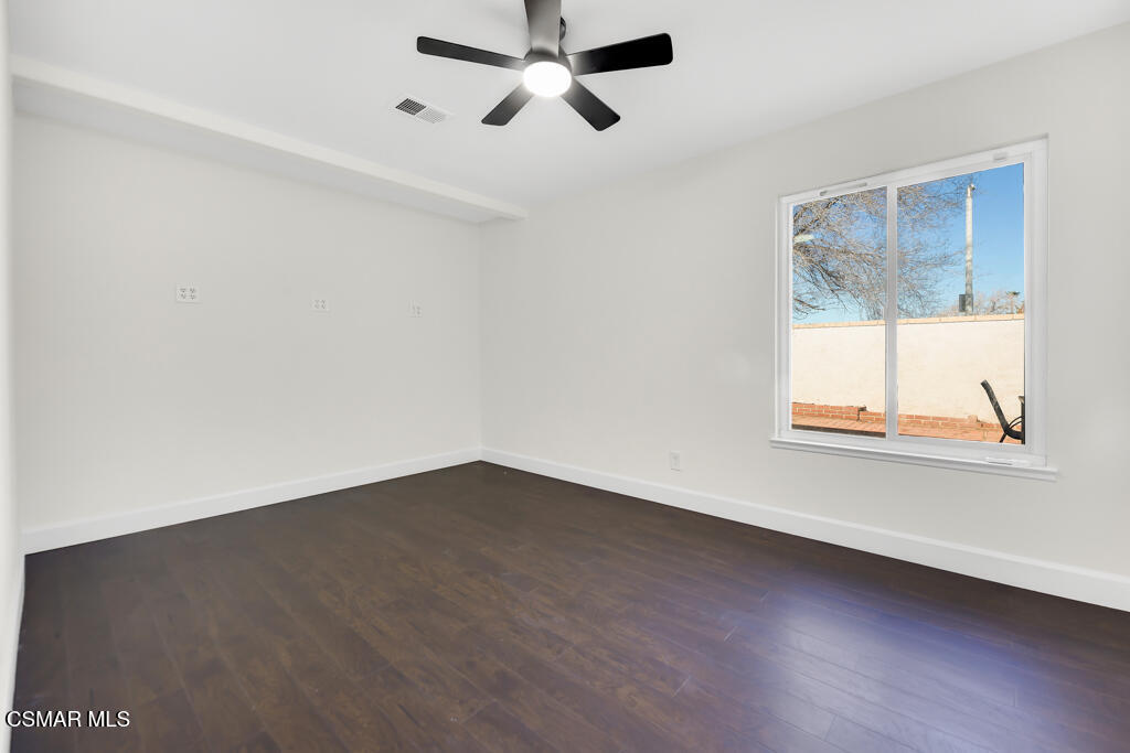 39202 Willowvale Road Palmdale, CA 93551 - Photo 23 of 36 an empty room with wooden floor and windows
