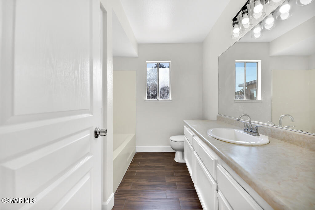 39202 Willowvale Road Palmdale, CA 93551 - Photo 24 of 36 a bathroom with a sink a toilet and shower