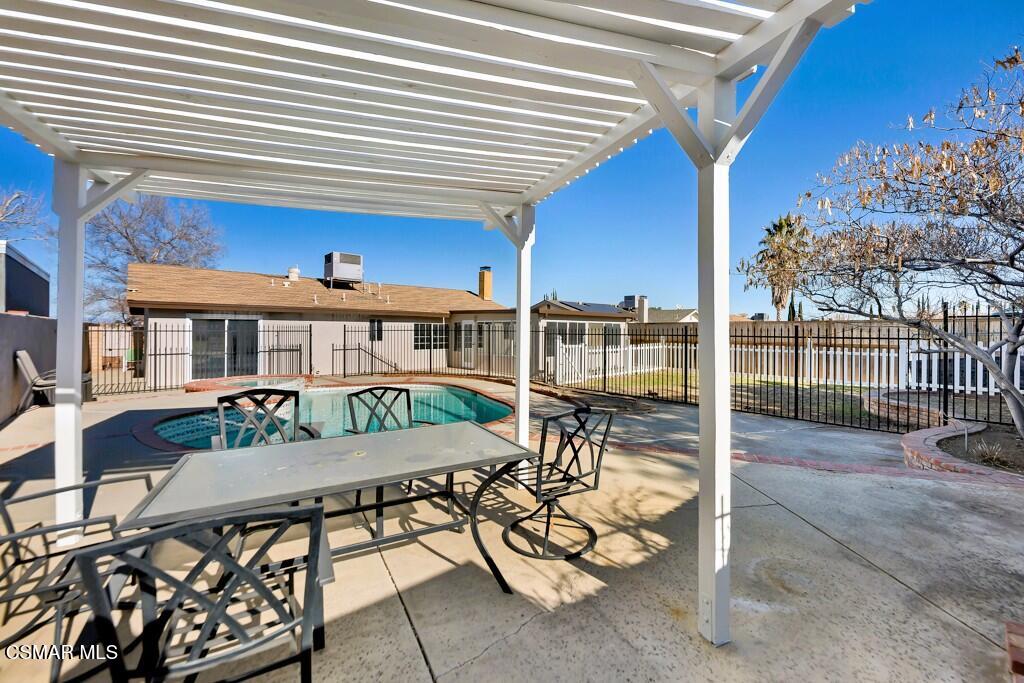 39202 Willowvale Road Palmdale, CA 93551 - Photo 5 of 36 a view of a patio with table and chairs with wooden floor and fence