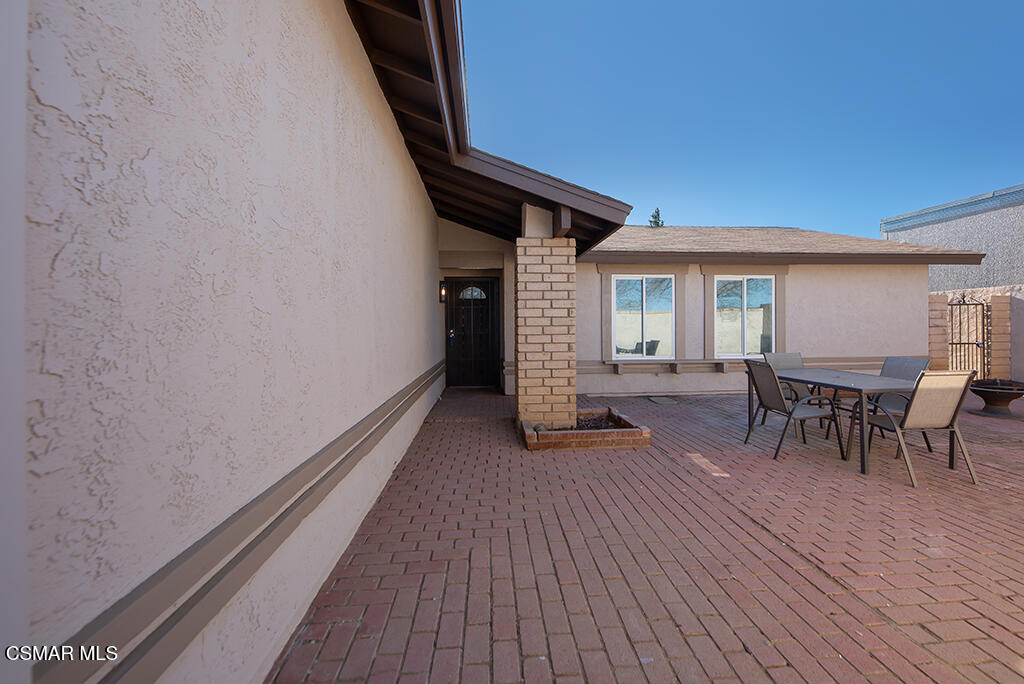 39202 Willowvale Road Palmdale, CA 93551 - Photo 7 of 36 a view of a patio with table and chairs with wooden floor and fence