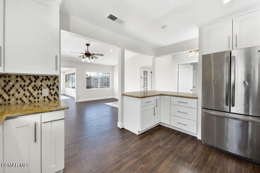 39202 Willowvale Road Palmdale, CA 93551 - Photo 10 of 36 a kitchen with stainless steel appliances a refrigerator and wooden floor