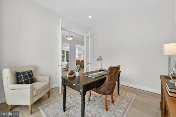 a living room with furniture and large windows