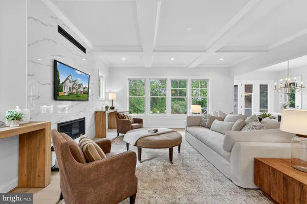 a living room with furniture and large windows