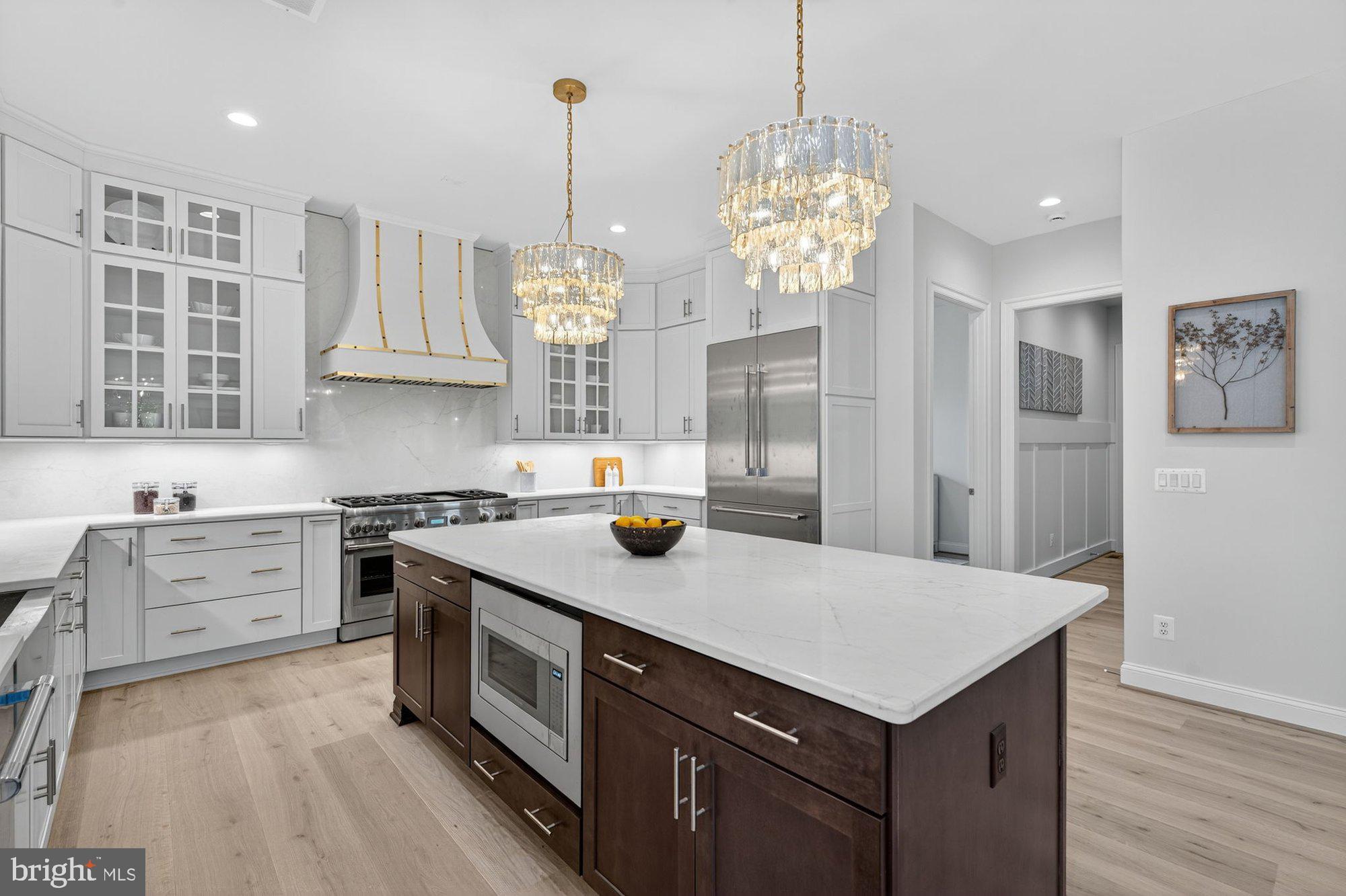 1436 Layman Street McLean, VA 22101 - Photo 29 of 105 a kitchen with stainless steel appliances granite countertop a sink a stove and a wooden floors