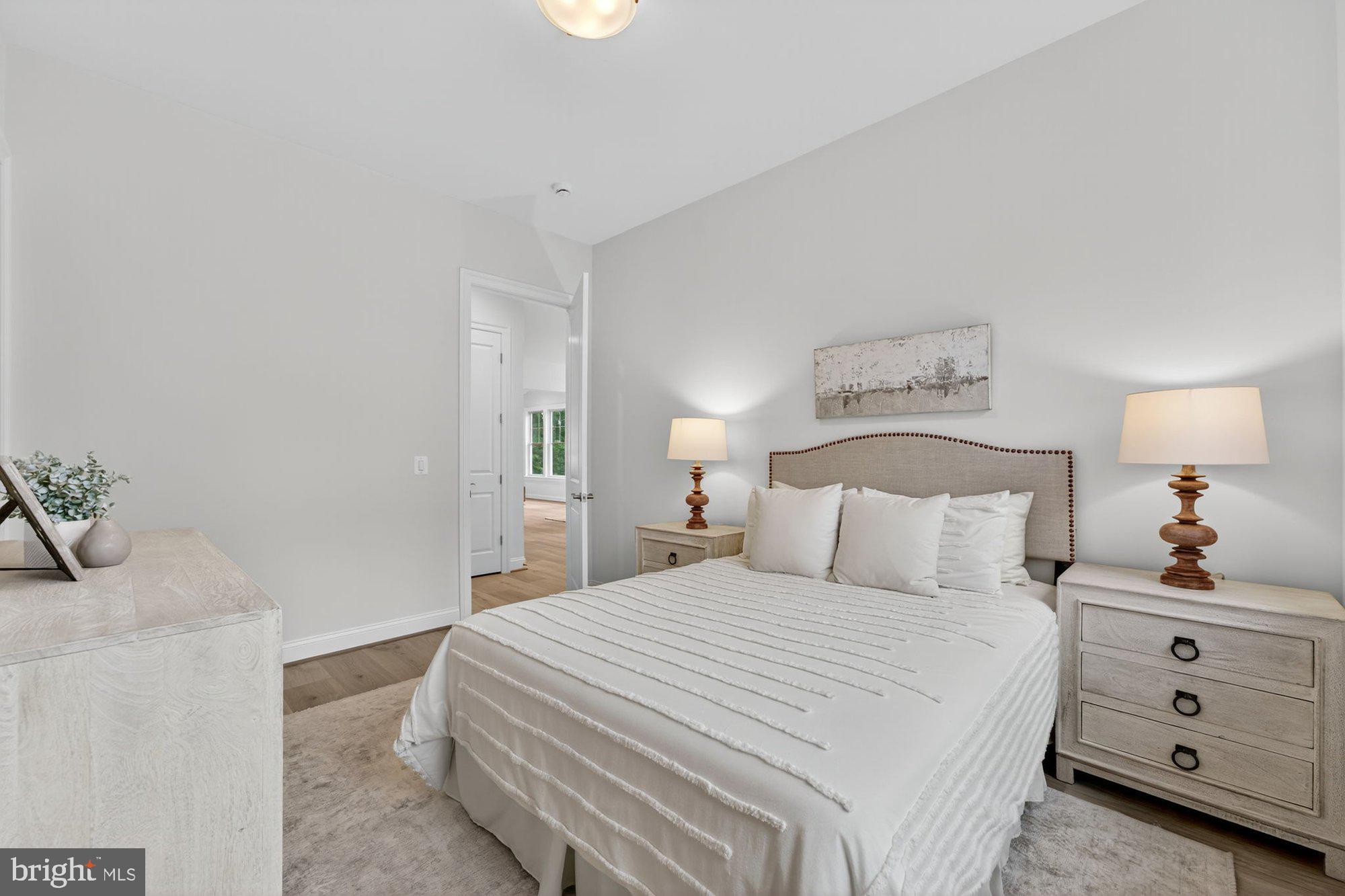 1436 Layman Street McLean, VA 22101 - Photo 39 of 105 a bedroom with a bed and a lamp on dresser