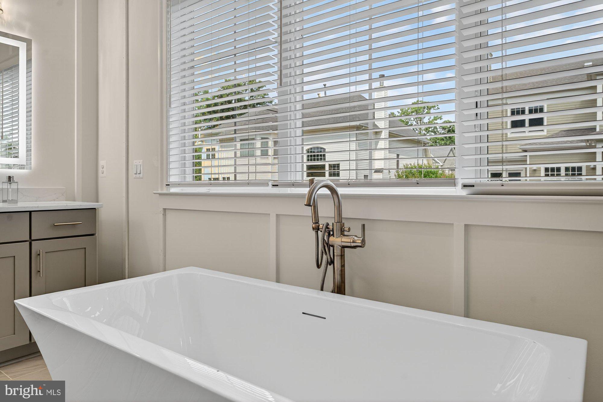1436 Layman Street McLean, VA 22101 - Photo 71 of 105 a bathroom with a bathtub and a window
