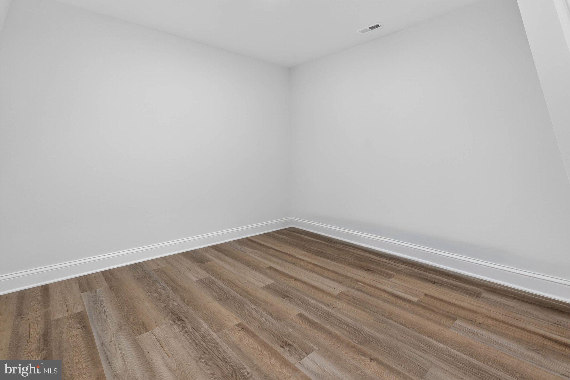 1436 Layman Street McLean, VA 22101 - Photo 87 of 105 a view of an empty room with wooden floor