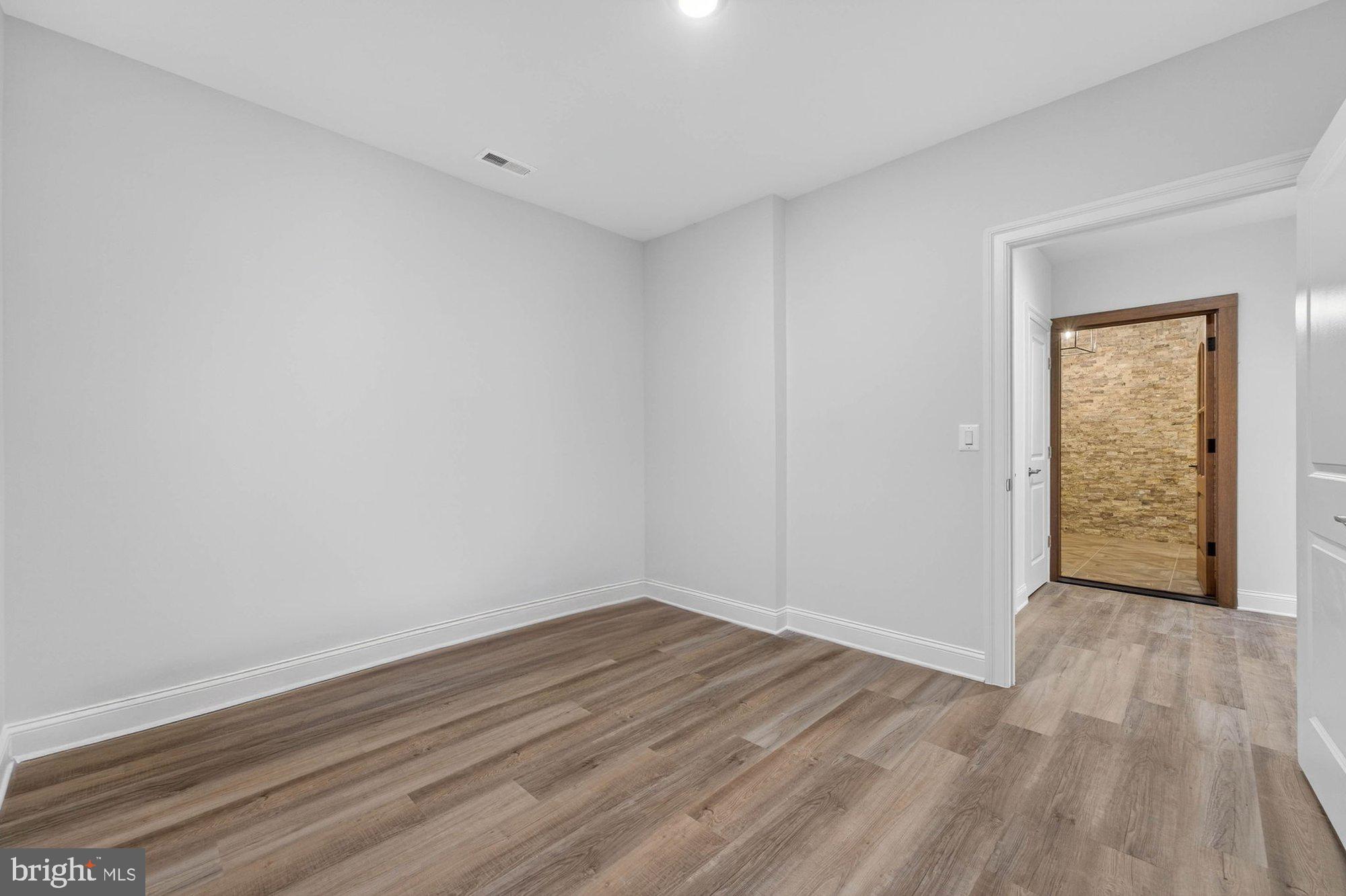 1436 Layman Street McLean, VA 22101 - Photo 88 of 105 a view of an empty room with wooden floor and a window