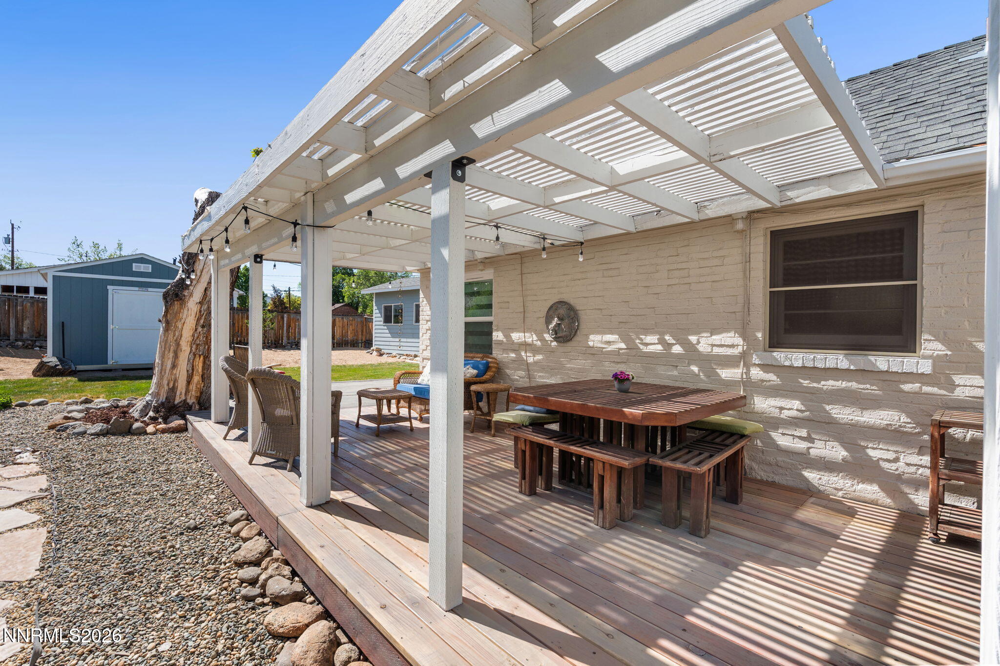300 Country Club Drive Reno, NV 89509 - Photo 37 of 48 a roof deck with table and chairs a barbeque with wooden floor and fence