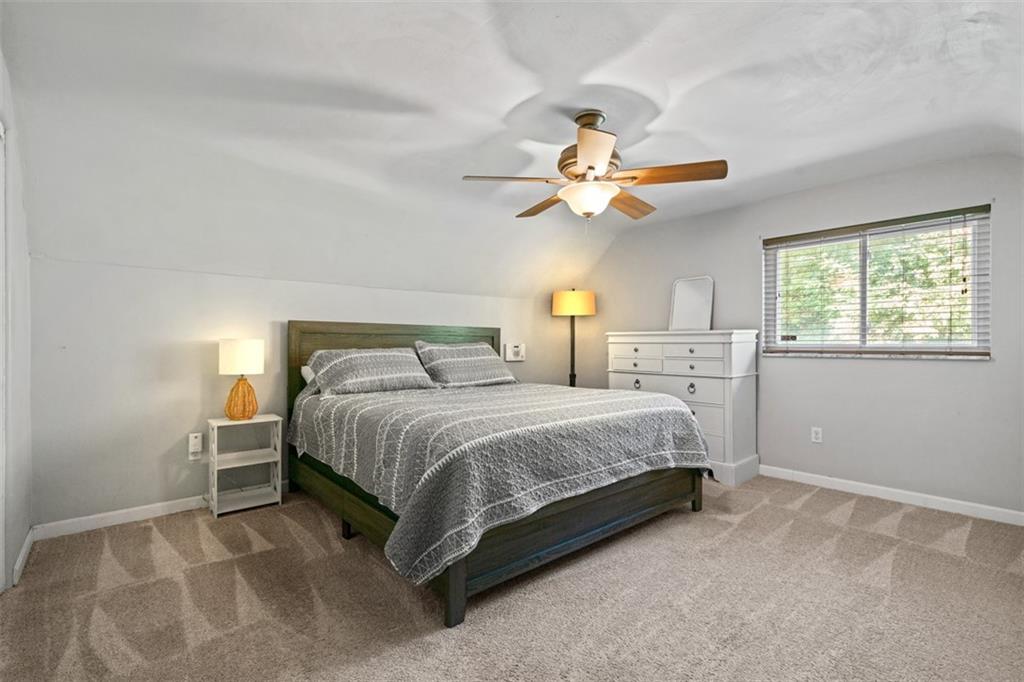 1538 Rutherford Avenue Pittsburgh, PA 15216 - Photo 17 of 43 a bedroom with a large bed and a chandelier