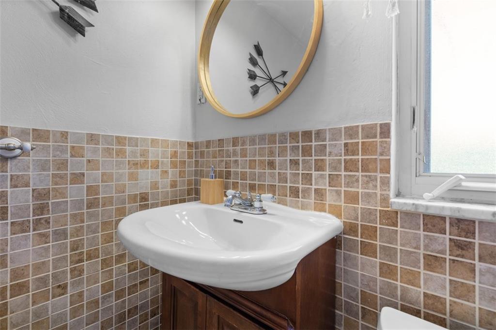 1538 Rutherford Avenue Pittsburgh, PA 15216 - Photo 20 of 43 a bathroom with a sink a mirror and a window