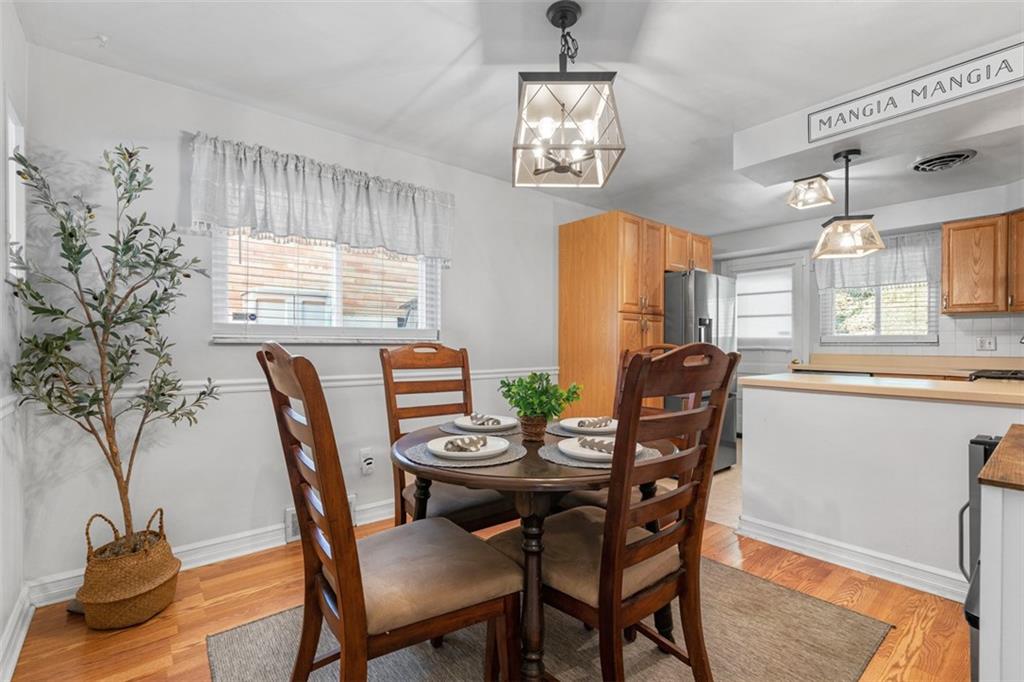 1538 Rutherford Avenue Pittsburgh, PA 15216 - Photo 21 of 43 a view of a dining room with furniture and a chandelier