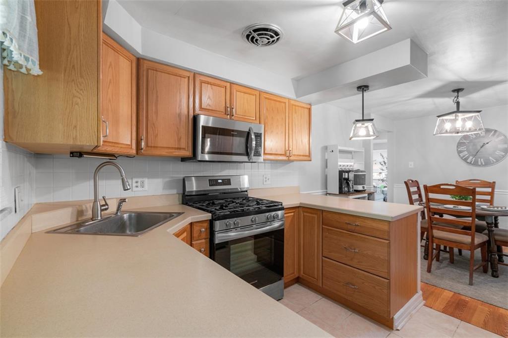 1538 Rutherford Avenue Pittsburgh, PA 15216 - Photo 26 of 43 a kitchen with a sink a stove and cabinets