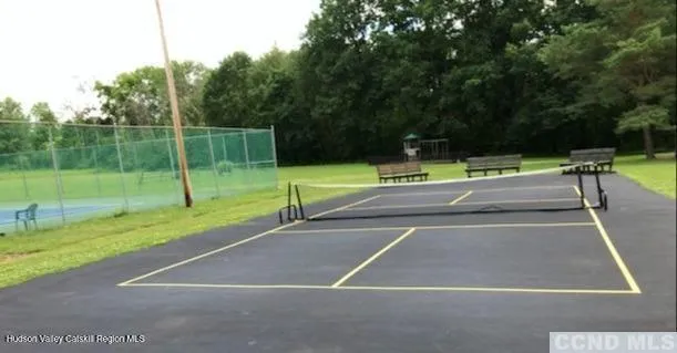 a view of a tennis court with a small yard