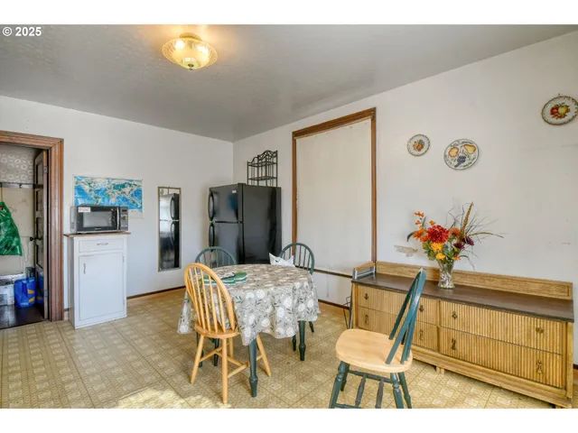 a view of a dining room with furniture and a large window