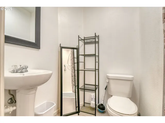 a bathroom with a sink a toilet and a window