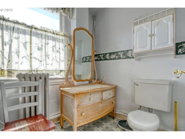 a bathroom with a toilet sink and mirror