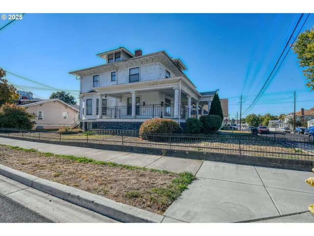 a front view of a house with shrubs
