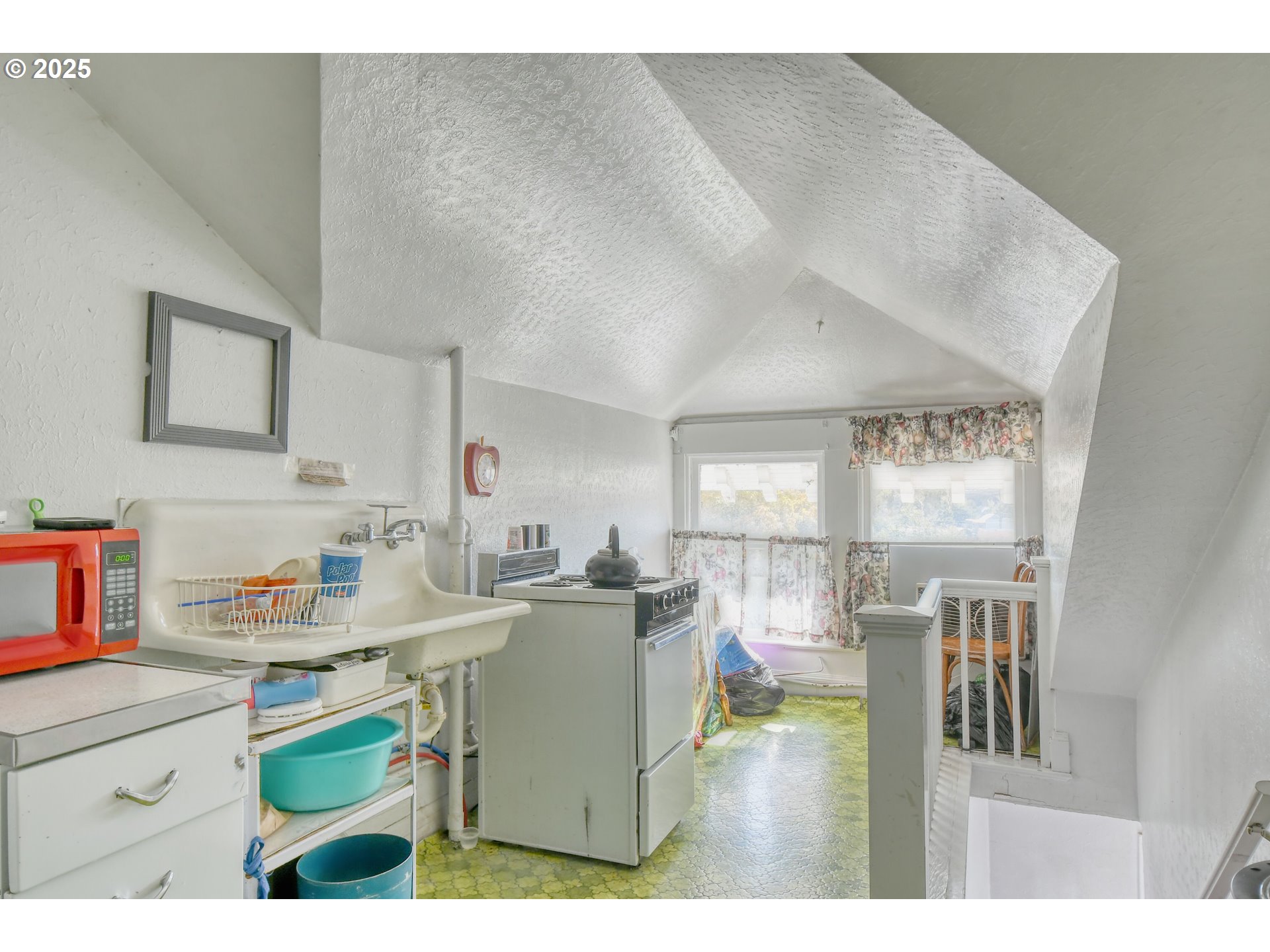 714 Southeast Byers Avenue Pendleton, OR 97801 - Photo 38 of 46 a kitchen with a sink dishwasher a stove and a dining table with wooden cabinet