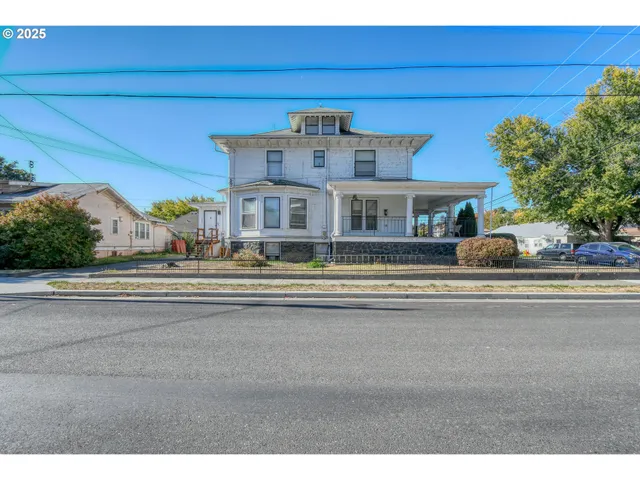 a front view of a house with a garden and plants