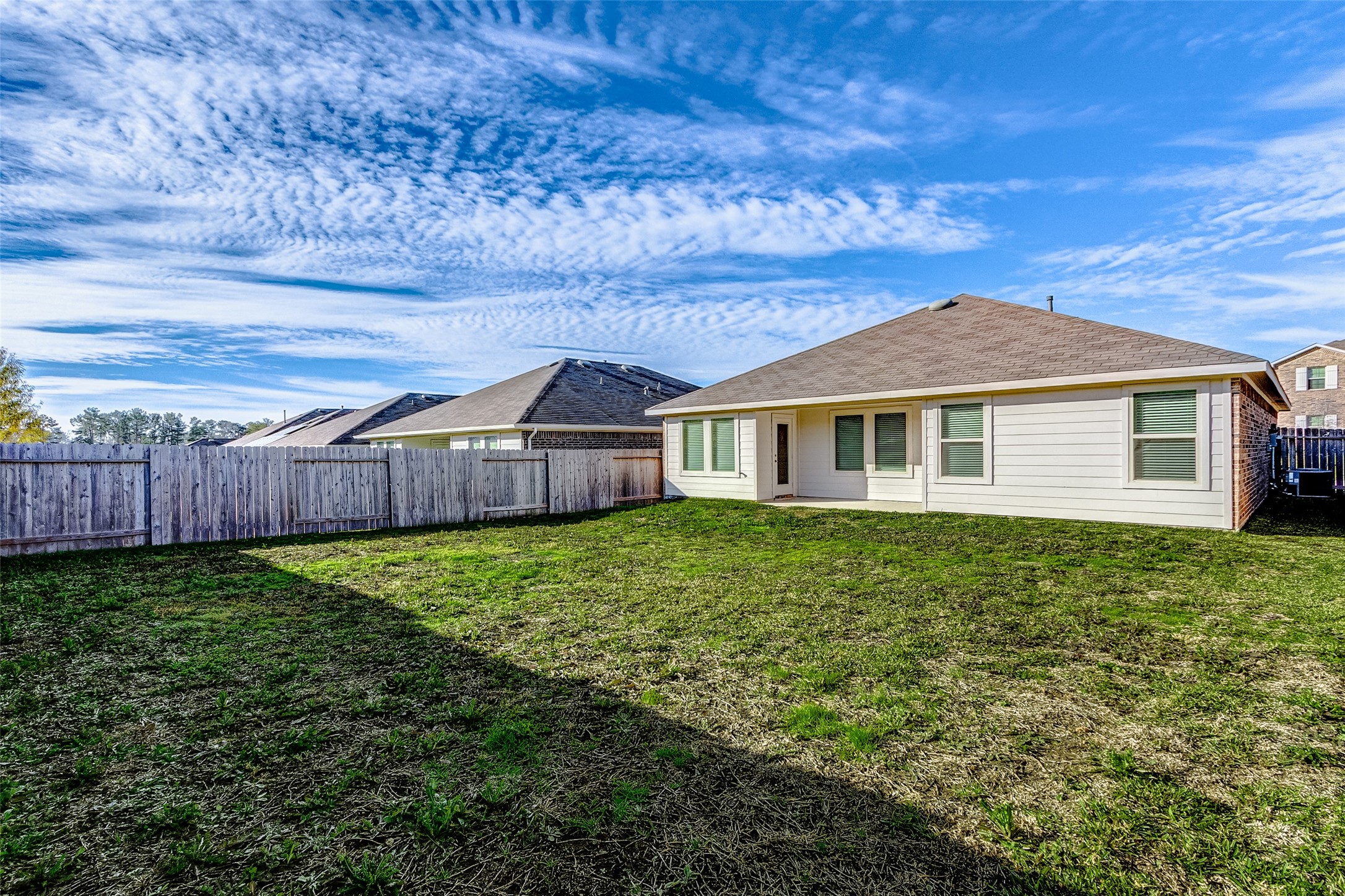 40454 Red Poppy Lane Magnolia, TX 77354 - Photo 22 of 23 a view of a yard in front of a house with wooden fence