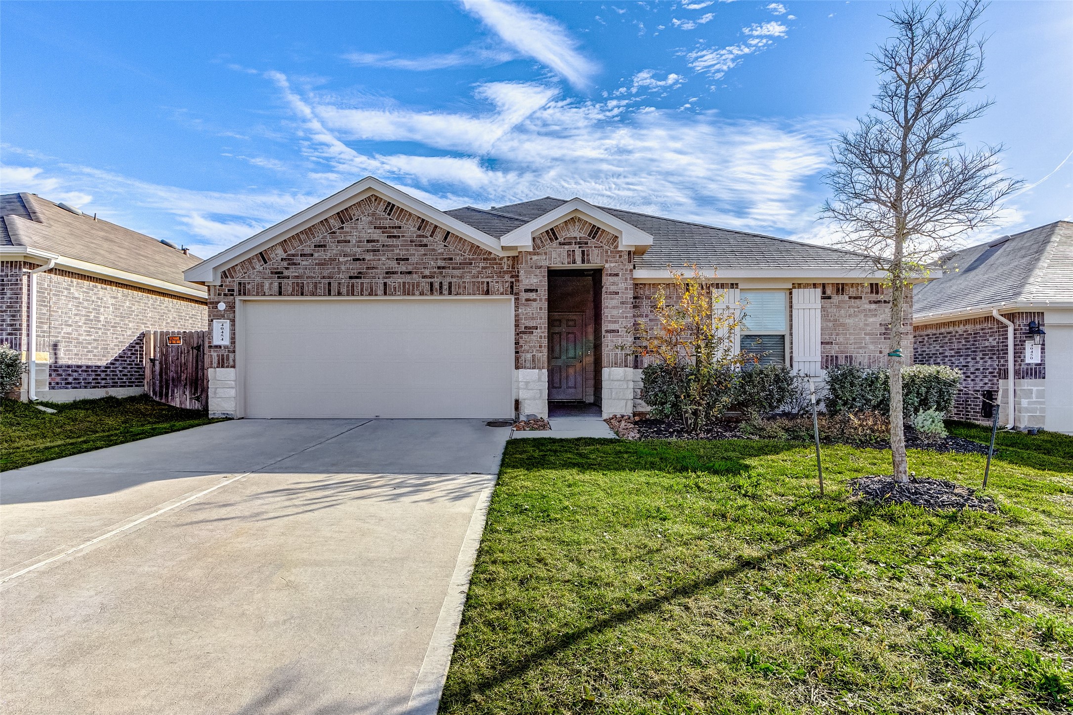 40454 Red Poppy Lane Magnolia, TX 77354 - Photo 3 of 23 a front view of a house with a yard and garage