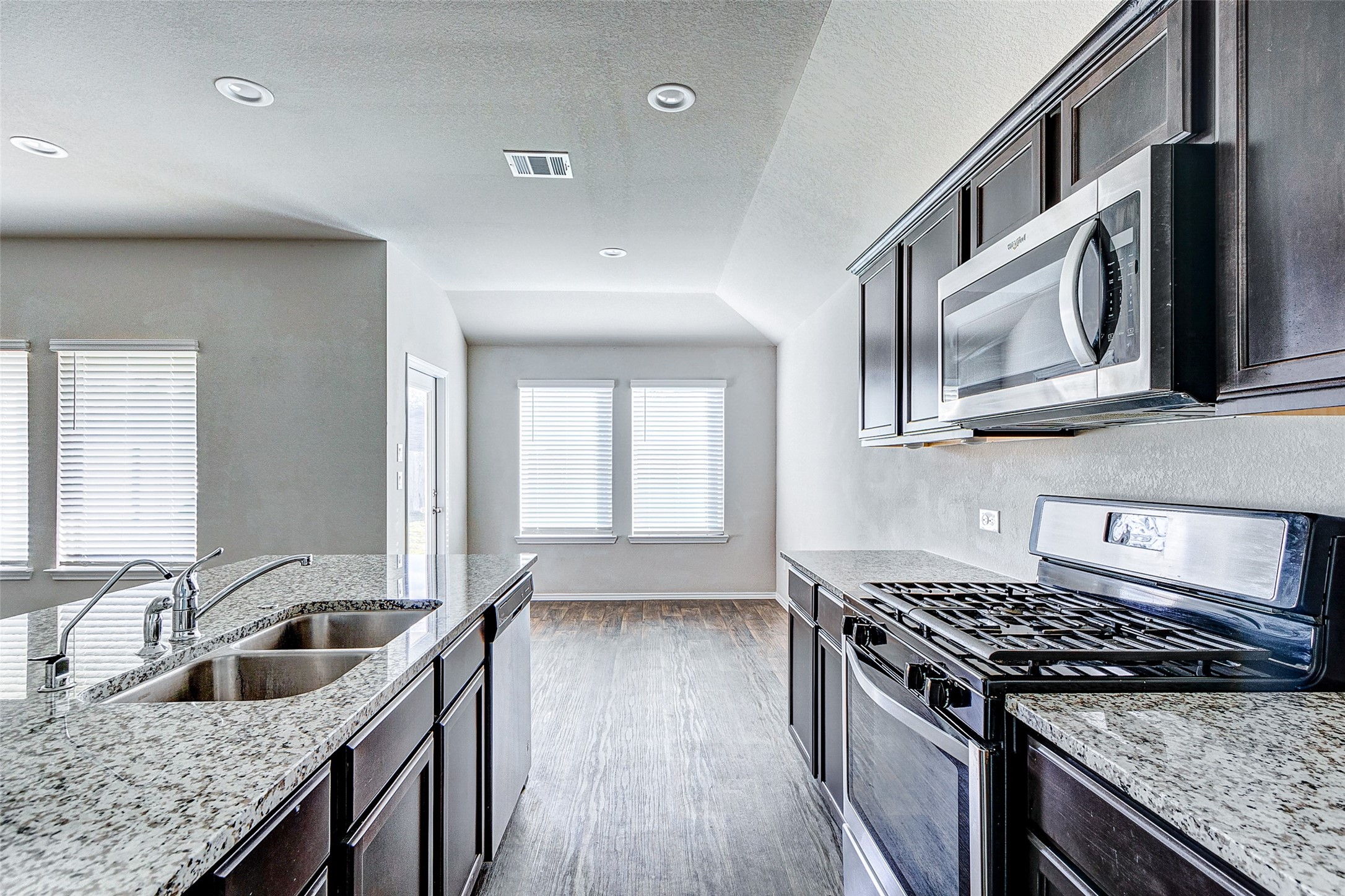 40454 Red Poppy Lane Magnolia, TX 77354 - Photo 7 of 23 a kitchen that has a sink wooden cabinets and stainless steel appliances