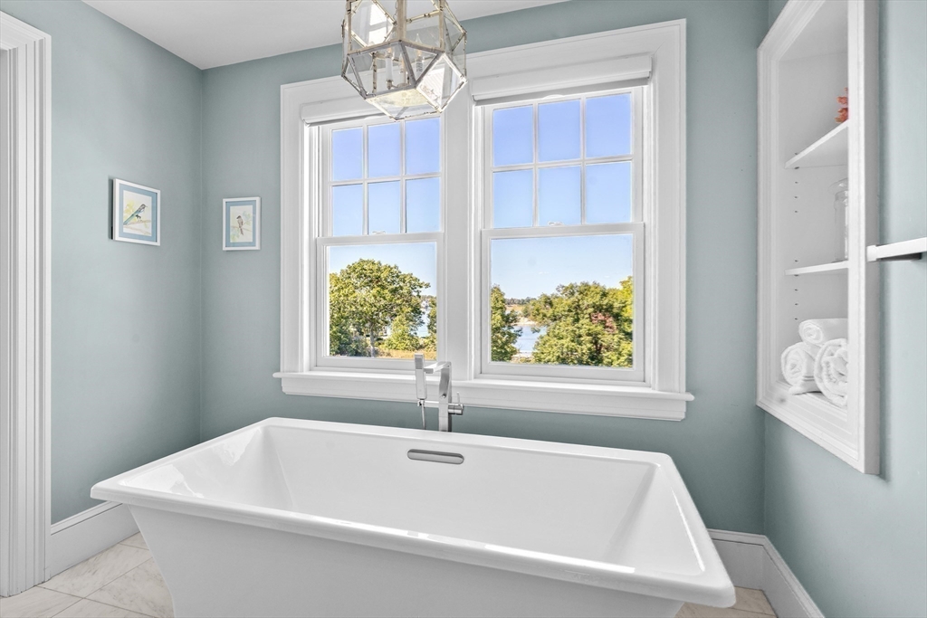 17 Mohawk Way Cohasset, MA 02025 - Photo 15 of 33 a white bath tub sitting next to a window