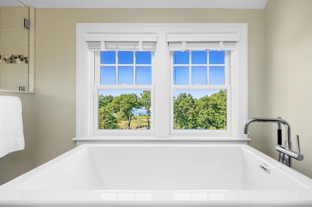 17 Mohawk Way Cohasset, MA 02025 - Photo 19 of 33 a white bath tub sitting in a bathroom next to a window