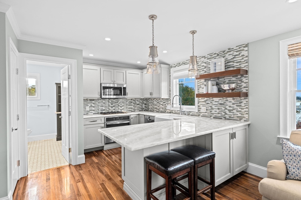 17 Mohawk Way Cohasset, MA 02025 - Photo 30 of 33 a large kitchen with kitchen island a large counter space a sink appliances and cabinets