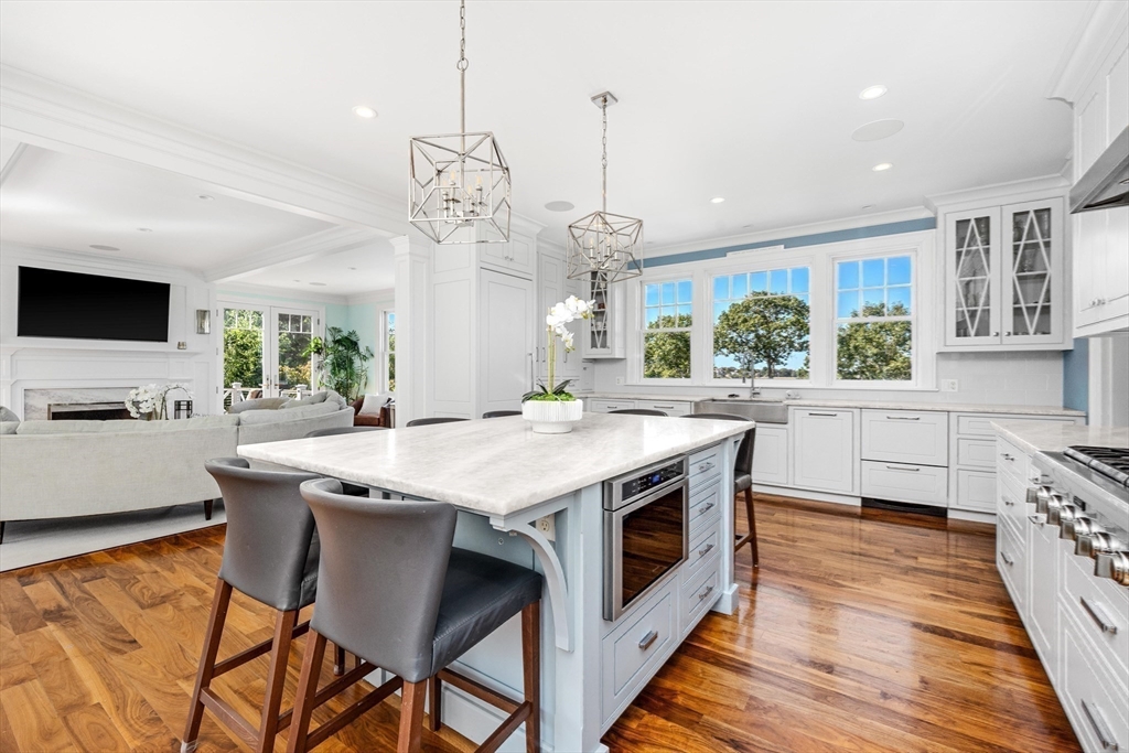 17 Mohawk Way Cohasset, MA 02025 - Photo 3 of 33 a kitchen with stainless steel appliances granite countertop a stove a refrigerator a oven a sink with a dining table and chairs