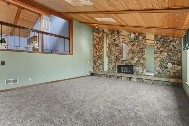 a bedroom with a bed and windows