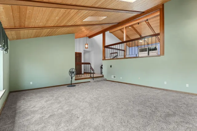 an empty room with a ceiling fan and a window