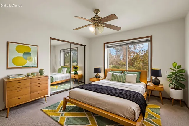 a bedroom with a bed and a painting on the wall