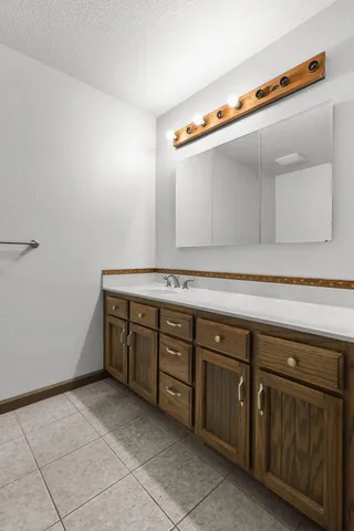 a bedroom with a balcony a bed and a painting on the wall