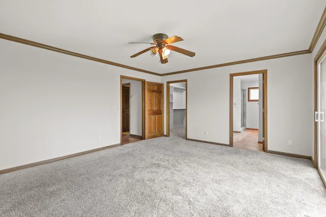a view of a room with wooden floor and a window