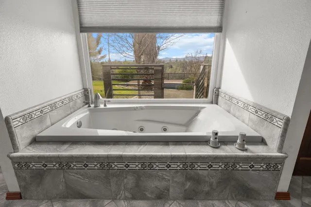 a large kitchen with stainless steel appliances wooden cabinets a sink and dishwasher