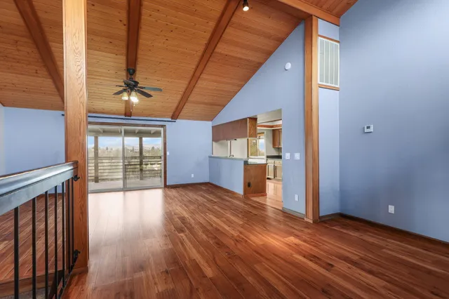 a view of a room with wooden floor
