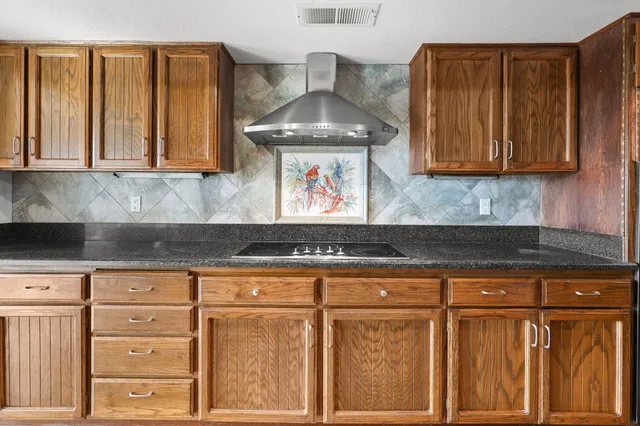 a view of a balcony with wooden floor and fence