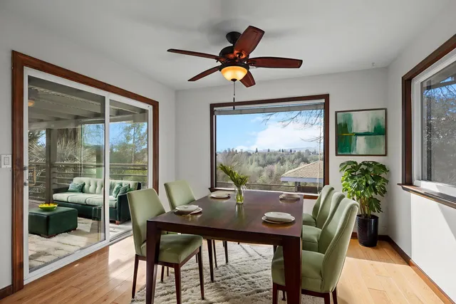 a front view of a house with a yard and palm trees