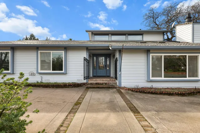 a front view of a house with a yard