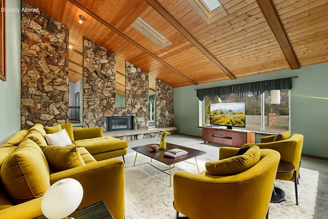 a view of an empty room with a fireplace and a window