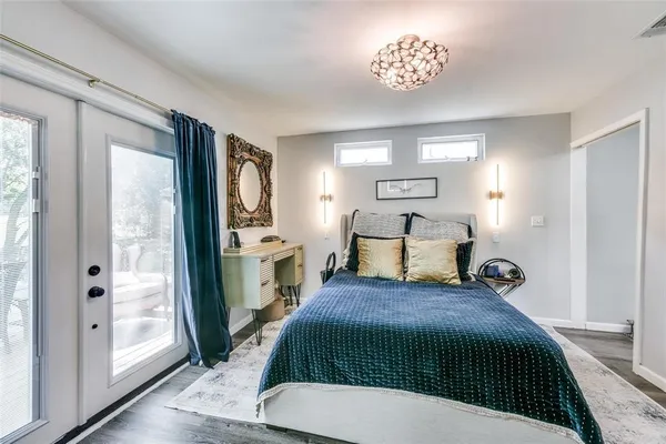 a spacious bedroom with a bed and a chandelier