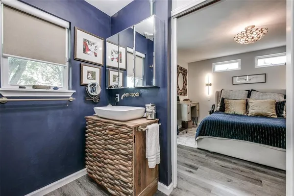 a spacious bedroom with a bed and a chandelier