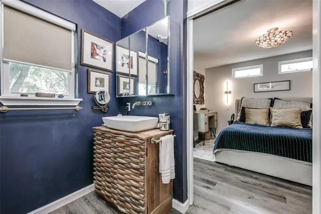 a spacious bedroom with a bed and a chandelier