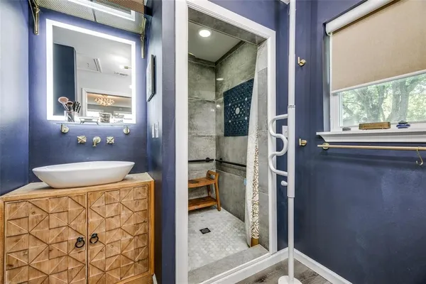 a bathroom with a granite countertop sink and a mirror